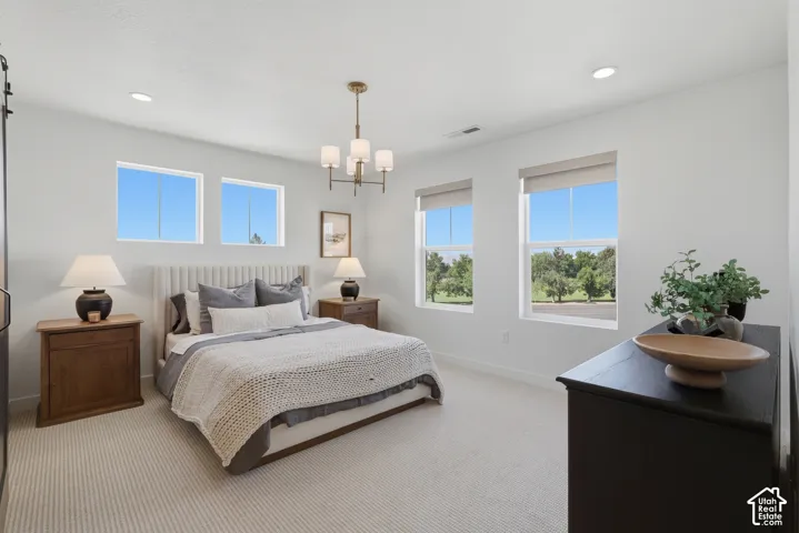 Recessed lighting, chandelier, and a carpeted floor