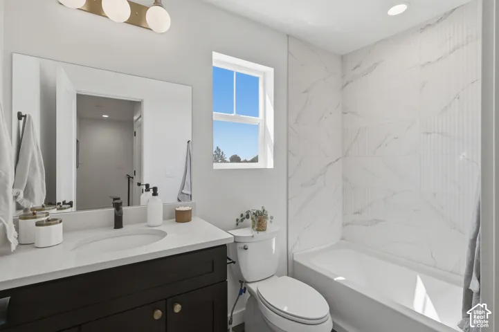 Modern bathroom featuring a single vanity with built-in sink, dark wood-finish cabinetry, and a full-width mirror