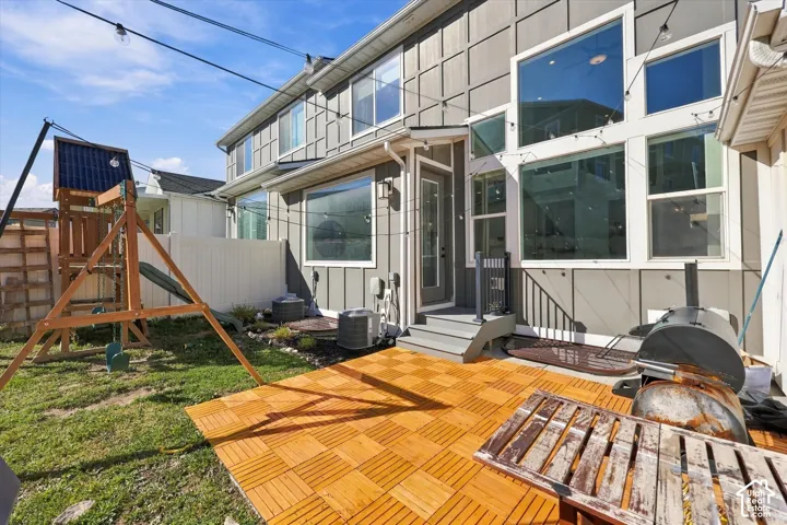 Backyard featuring a wood-finish patio, private fencing, and multi-pane windows