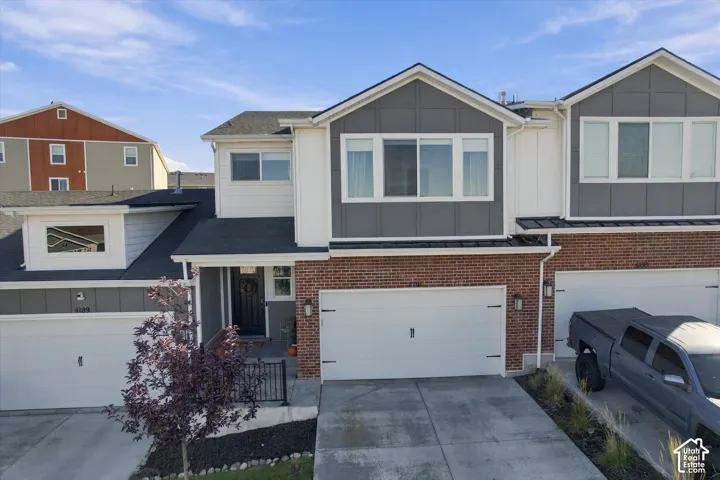 Contemporary exterior featuring brick and panel siding