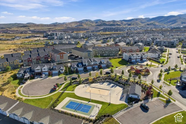 Expansive community featuring residential properties, a pickleball court, and a sand volleyball court