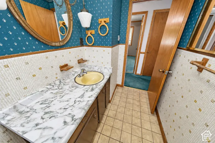 Vanity with a faux marble countertop and an oval sink