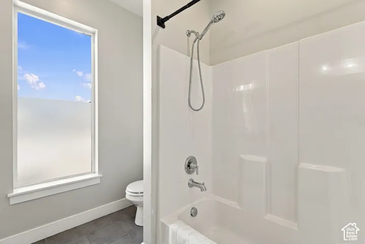 White shower/tub combination with chrome fixtures