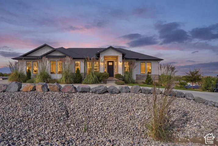 Contemporary ranch-style exterior with a dark roof and light siding