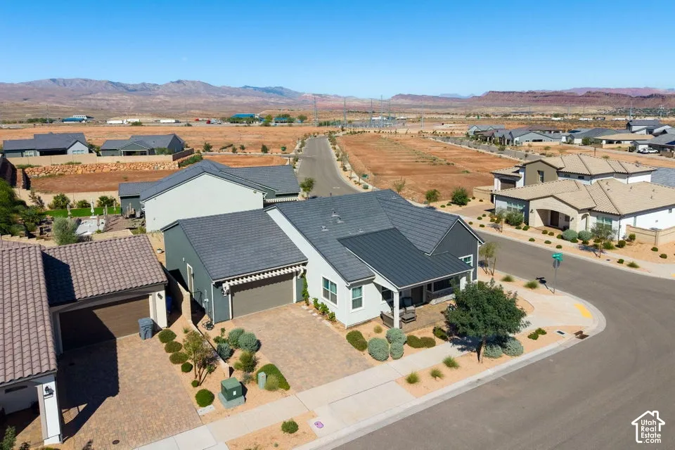 Modern residential architecture with a mixed-material facade, attached garage, and paved driveway