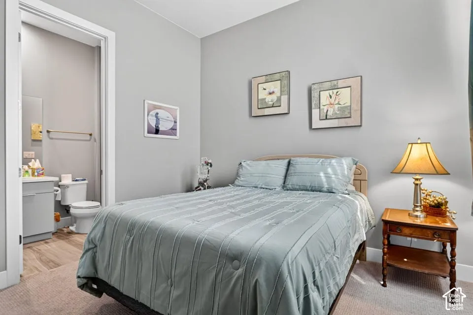 Carpeted bedroom with light gray walls and an open doorway