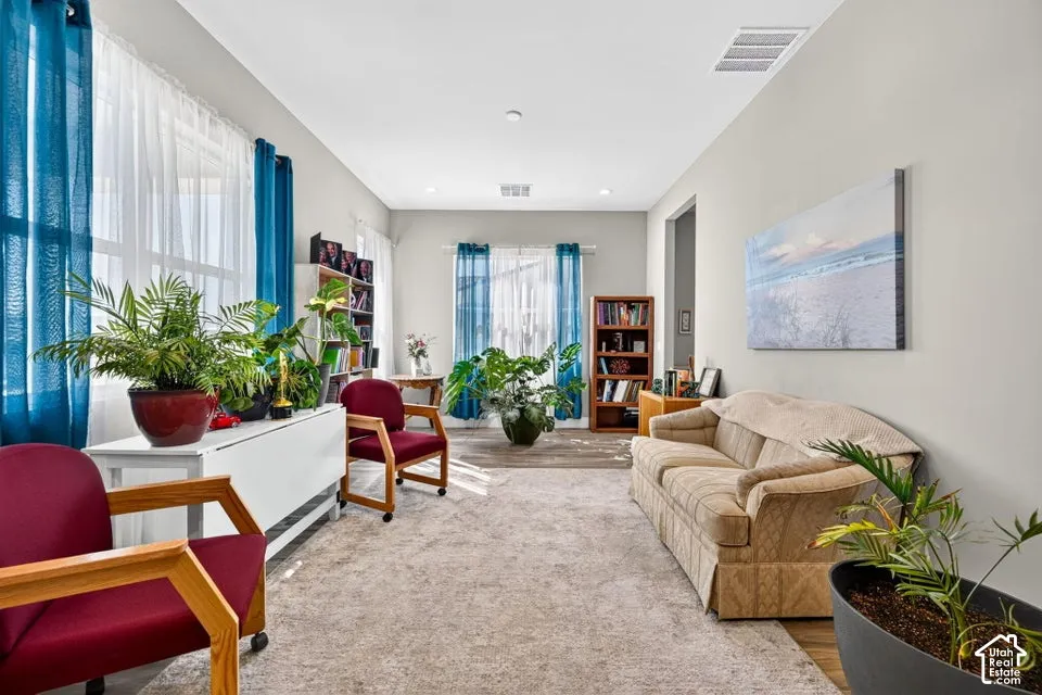 Recessed lighting, light-toned walls, and wood-finish flooring