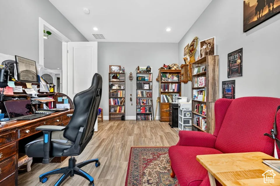 Wood-finish flooring, recessed lighting, and light gray walls