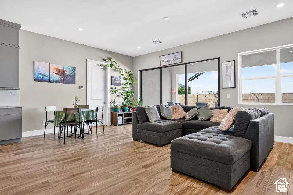 Wood-finish flooring throughout, recessed lighting, and a neutral wall color