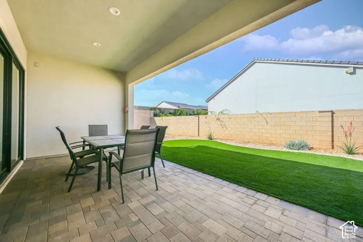 Covered patio with recessed lighting, paver flooring, and sliding glass door