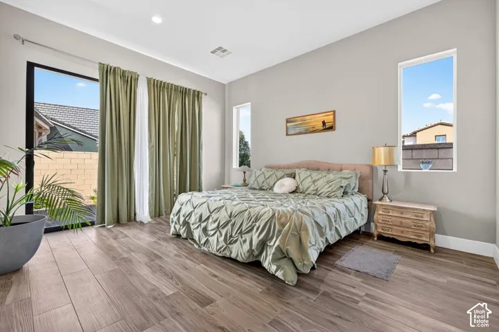Wood-finish flooring, recessed lighting, and a large sliding glass door