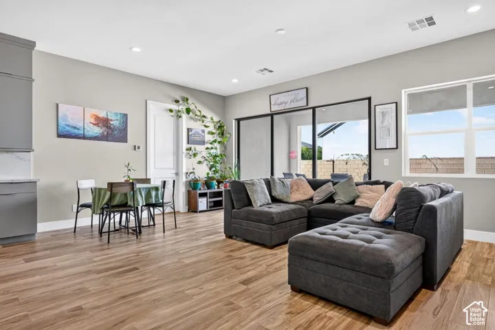 Wood-finish flooring throughout, recessed lighting, and a neutral wall color