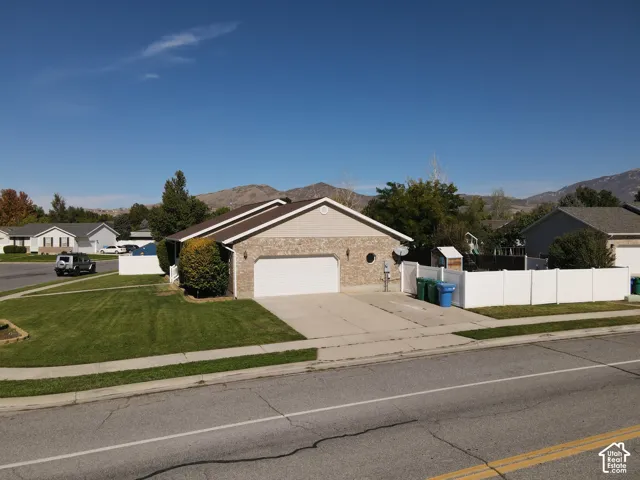 Single-story residence featuring a brick and siding exterior, an attached two-car garage, and a concrete driveway