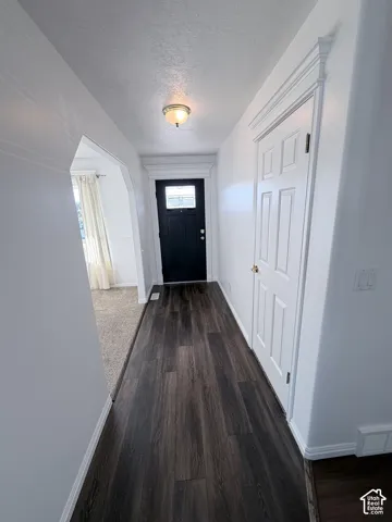 Dark LVP flooring with white baseboards