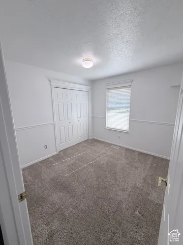 Neutral-toned wall-to-wall carpeting throughout