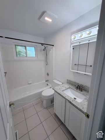 White vanity with an integrated sink and light-toned countertop