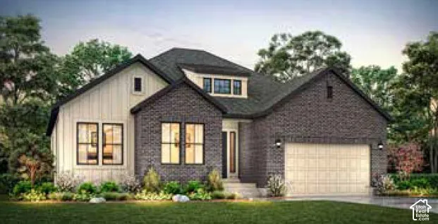 Contemporary home with dark brick and vertical siding, featuring a dormer window, an attached garage, and landscaped front yard