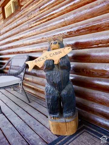 Log siding exterior with a natural wood finish, complemented by wood-plank decking