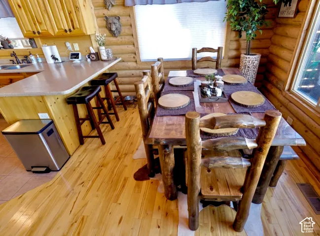 Wood-finish flooring throughout, light wood-finish cabinetry, and a light-toned countertop