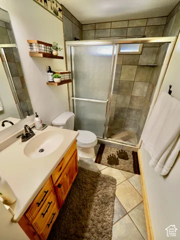 Wood-finish vanity with an integrated sink and bronze-finish hardware