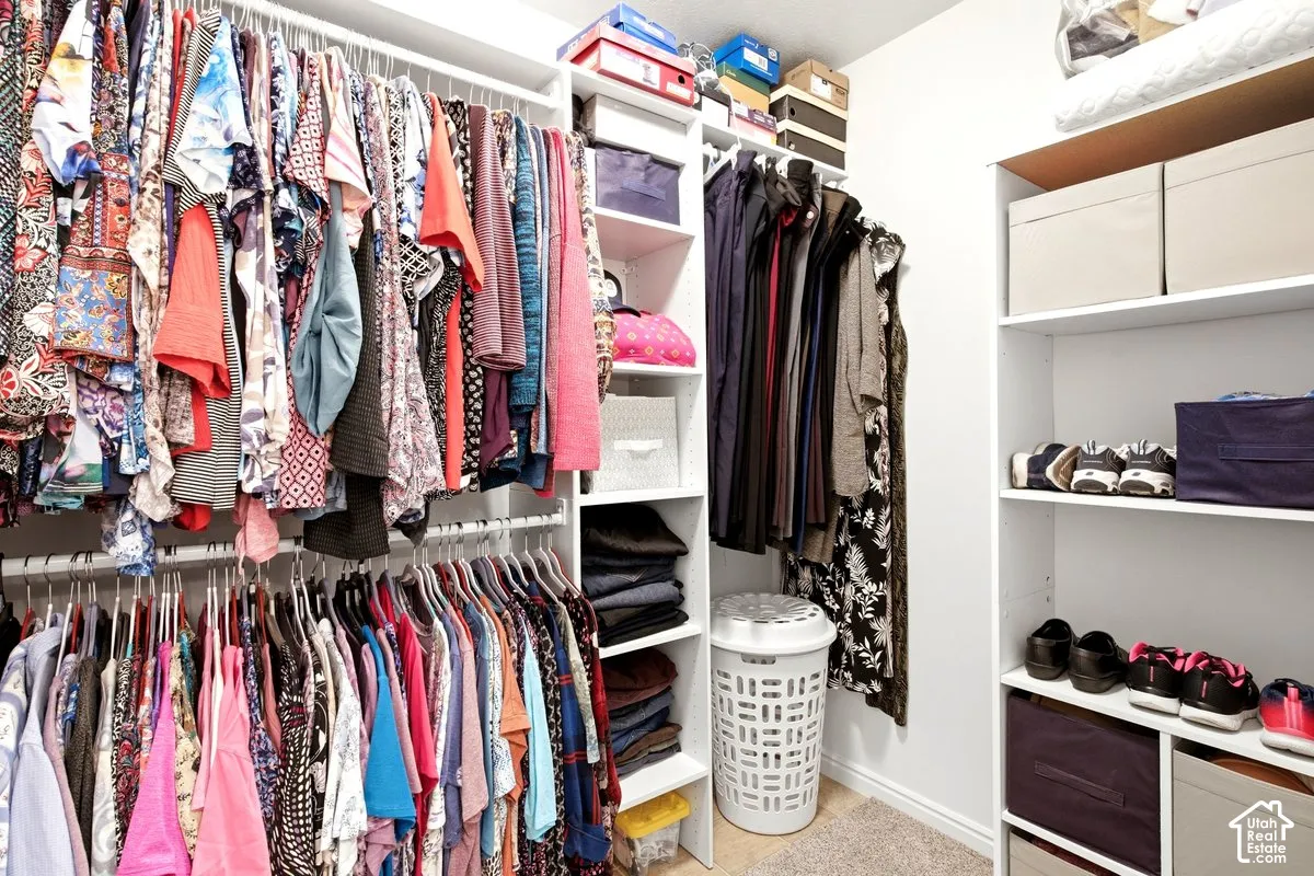 Built-in closet organization system with multiple hanging rods and shelving