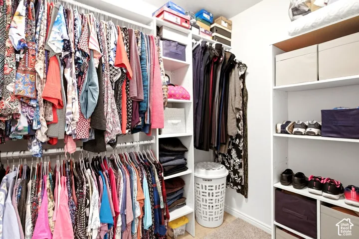 Built-in closet organization system with multiple hanging rods and shelving