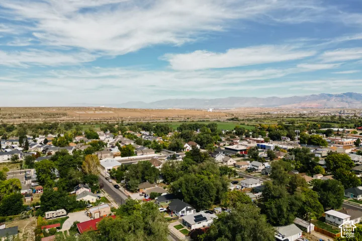 Expansive aerial perspective showcasing a residential area with mature trees and diverse architectural styles