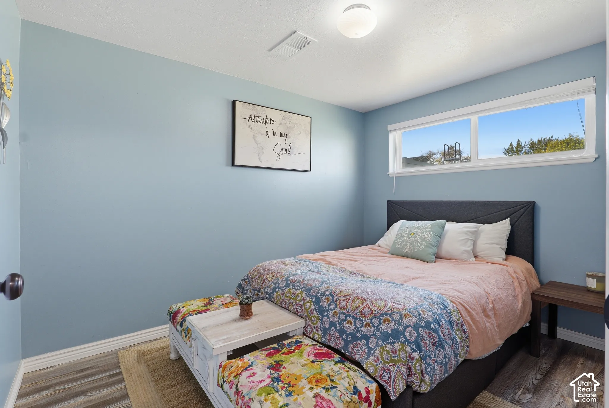 Recessed lighting, wood-finish flooring, and white trim