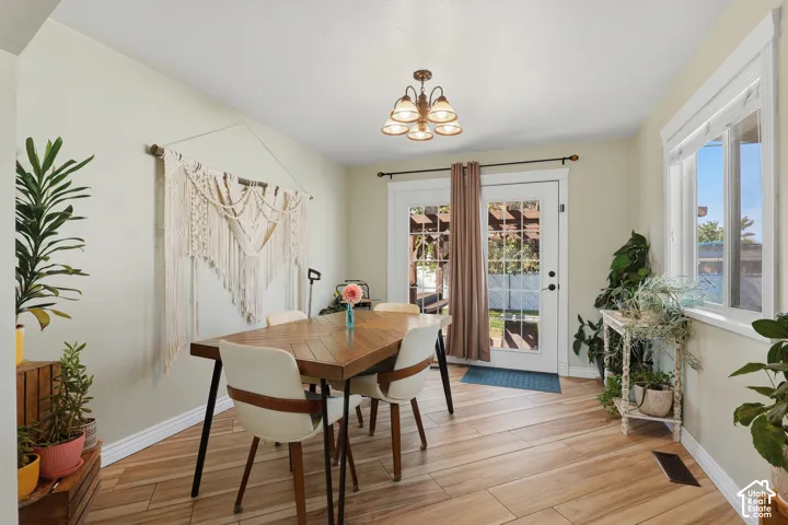 Wood-finish flooring, white trim, recessed window, and a glass-paneled door