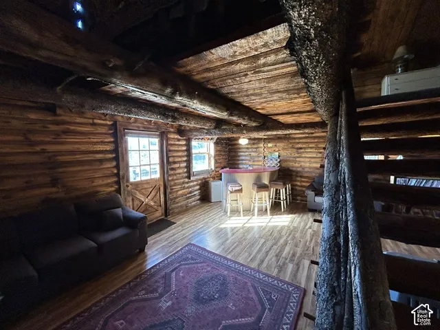 Log cabin interior featuring exposed wood beams and log walls