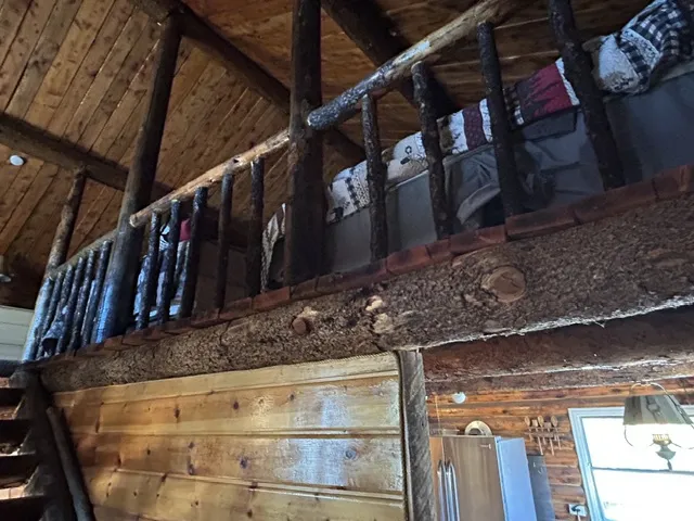 Wood-finish plank ceiling, natural wood-finish railings, and a wood-finish shiplap wall