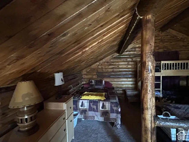 Log wall construction with exposed wood ceiling and structural wood beam