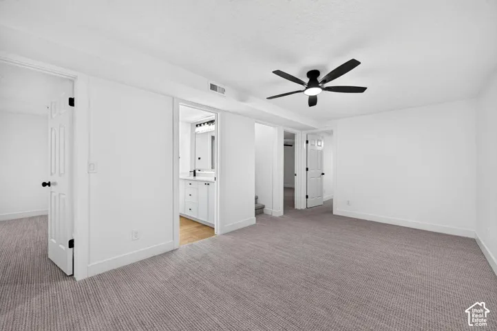 Recessed lighting, ceiling fan, neutral wall paint, carpet flooring, multiple doorways