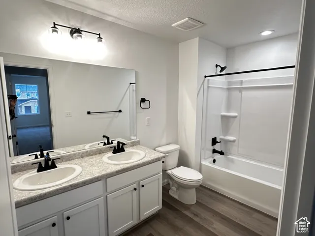 Dual vanity with white cabinetry and matte black hardware, accompanied by a full-sized mirror