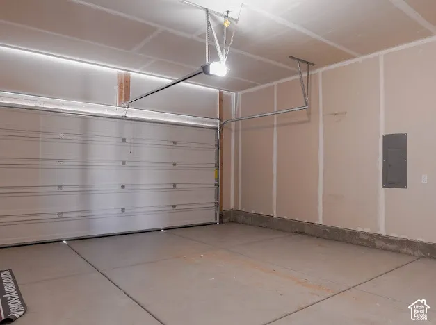 Attached garage featuring a concrete floor and neutral-toned walls