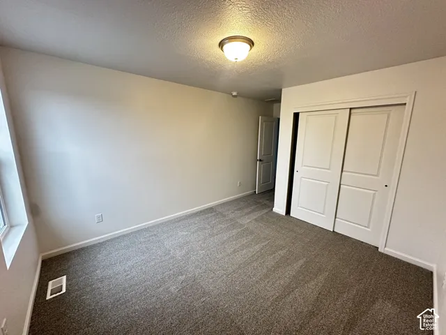 Neutral-toned walls complement the carpeted flooring