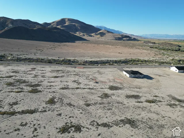 Expansive desert landscape with distant mountains and a paved road