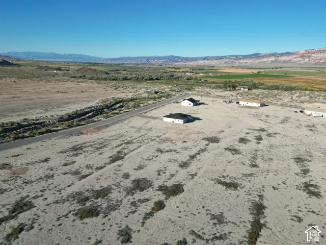 Expansive desert landscape with distant mountains and a paved road