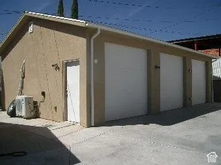 Stucco exterior with multiple garage doors