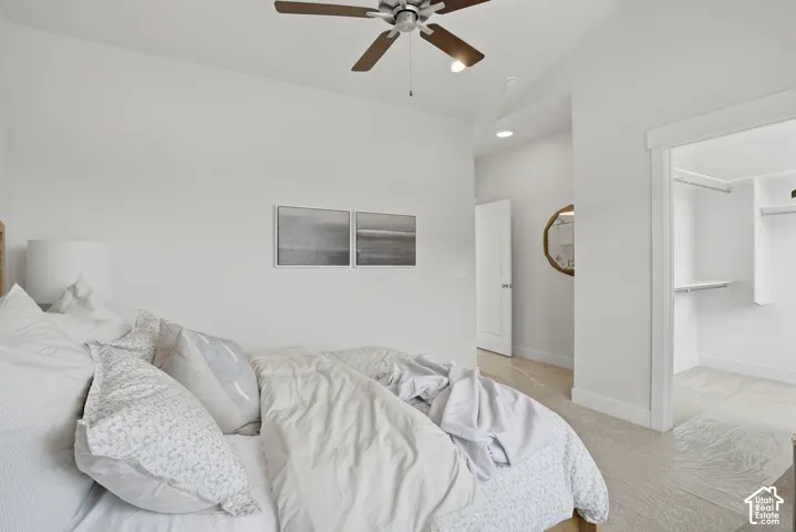 Recessed lighting, ceiling fan, built-in closet shelving, and a bright white interior