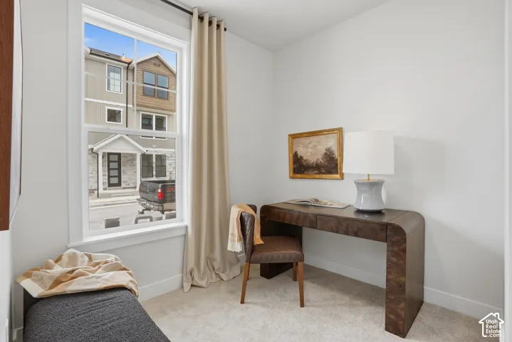 Crisp white walls, plush carpeting, and a large window with white trim