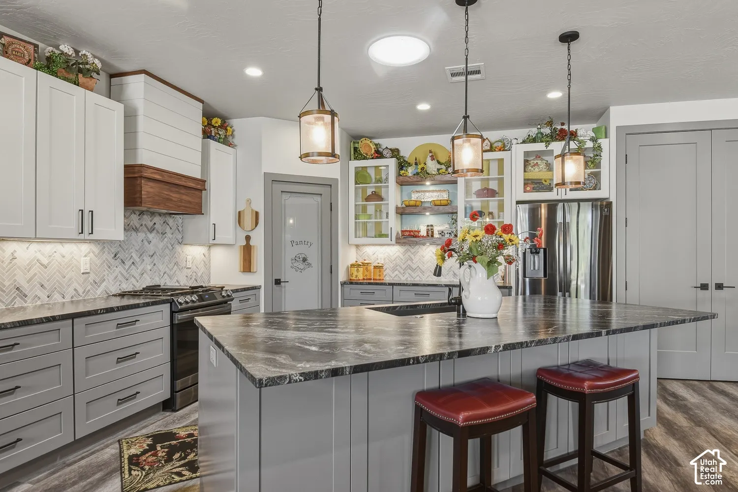 Kitchen with updated appliances, thoughtful finishes, and a storage closet in addition to the pantry