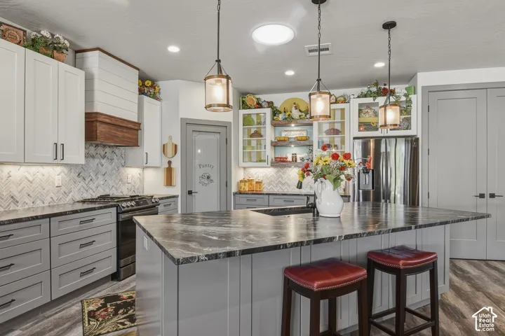 Kitchen with updated appliances, thoughtful finishes, and a storage closet in addition to the pantry