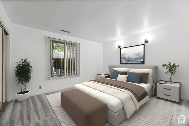 Wall-to-wall carpeting, window with vertical blinds, wall-mounted light fixtures, and a mirrored closet door