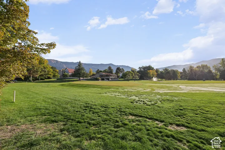 Expansive green space with distant mountain backdrop