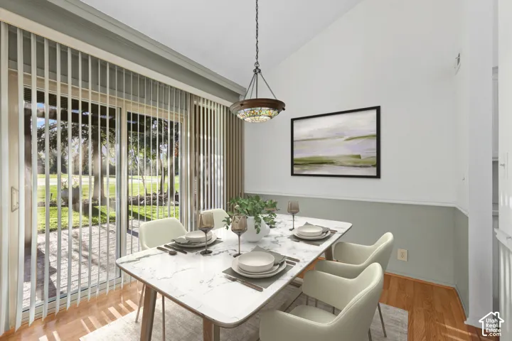 Vaulted ceiling, wood-finish flooring, glass sliding door, exterior patio, and built-in decorative lighting