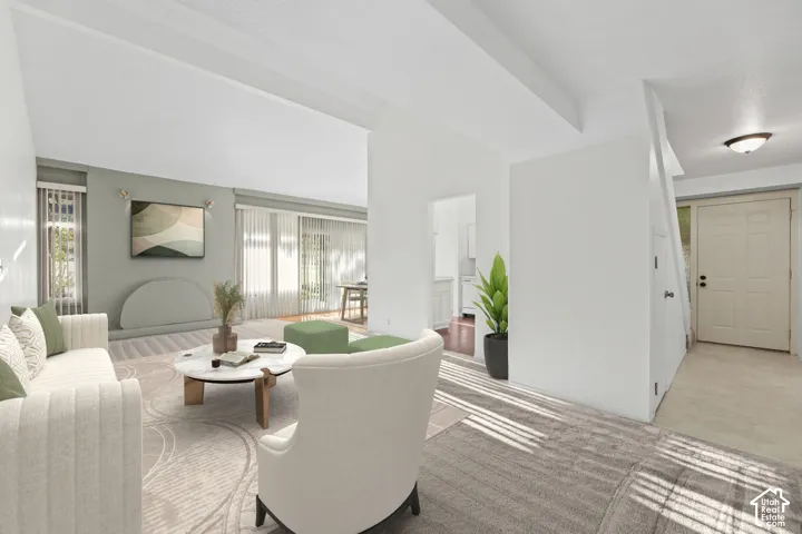 Spacious room featuring patterned carpeting, recessed lighting, and large windows with vertical blinds