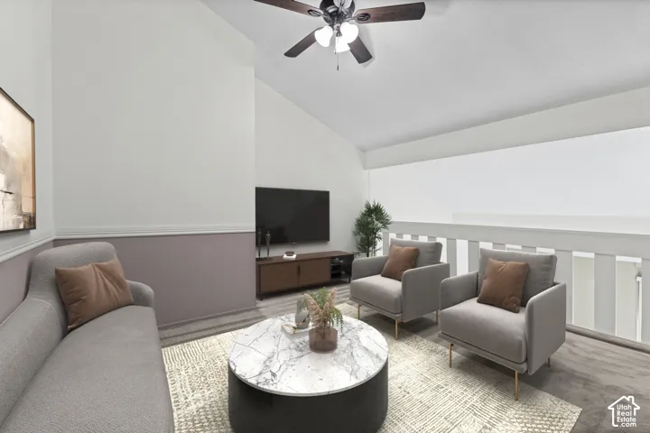 Carpeted loft area with a ceiling fan, white railings, and two-tone wall treatment