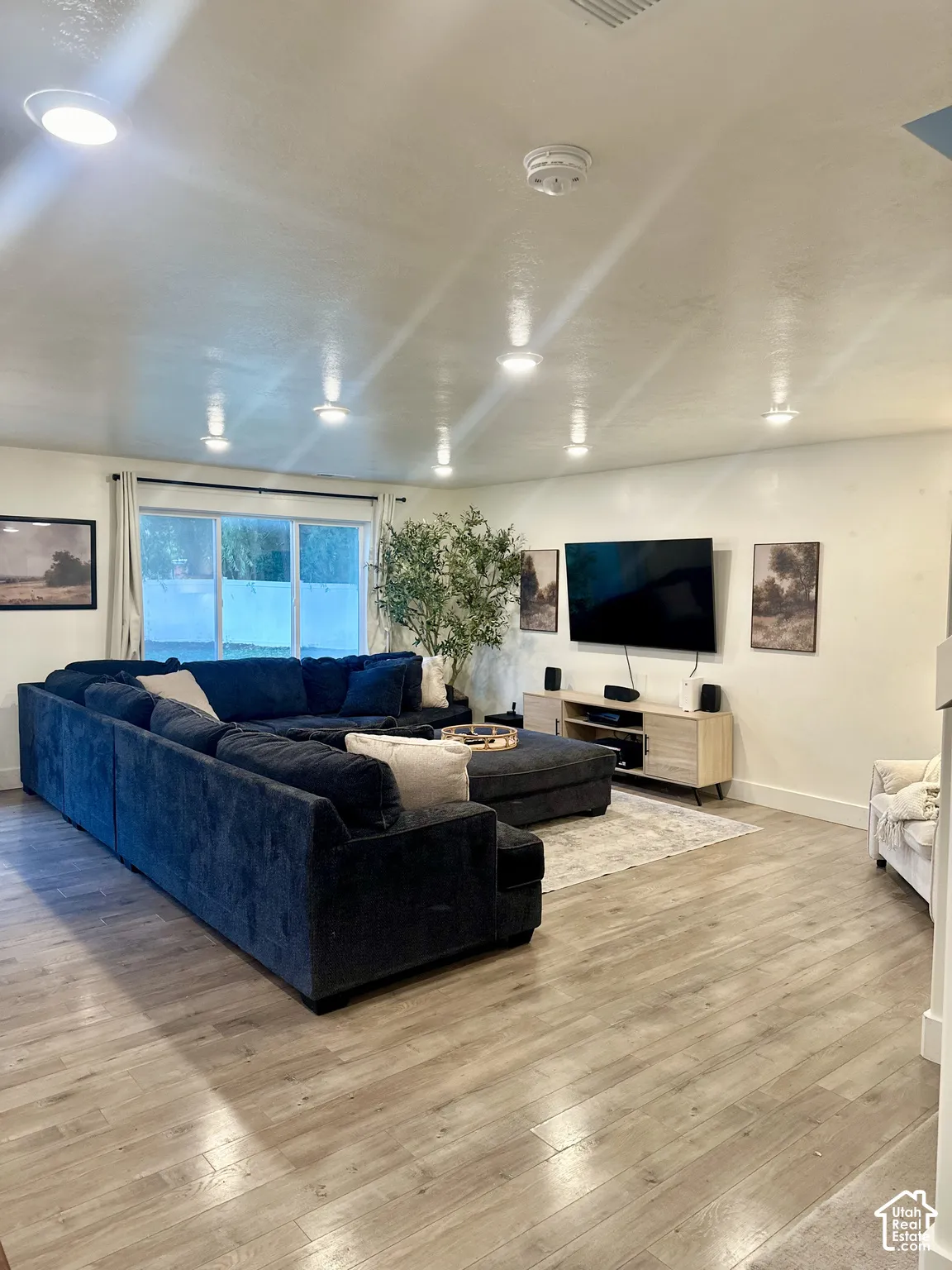 Recessed lighting, wood-finish flooring, and large windows