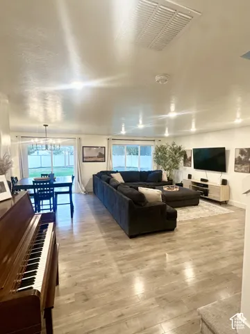 Recessed lighting throughout, wood-finish flooring, and multiple windows